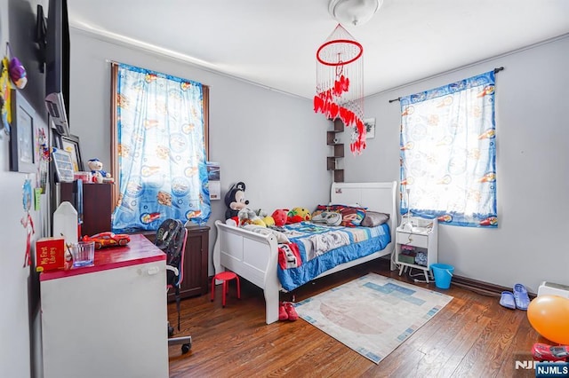 bedroom with wood finished floors