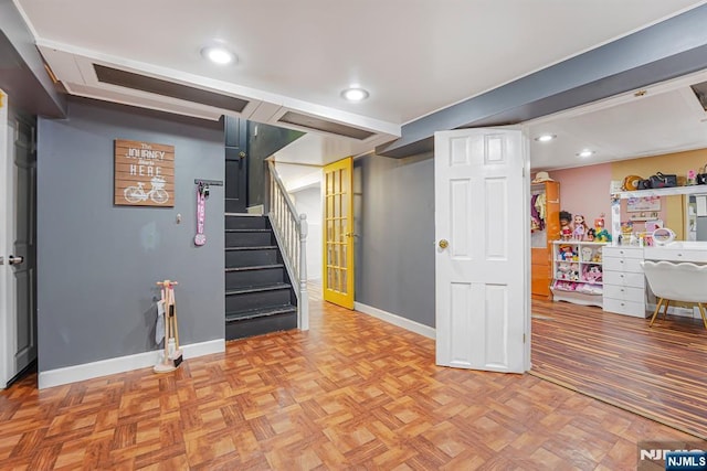 finished below grade area with stairs, baseboards, and recessed lighting