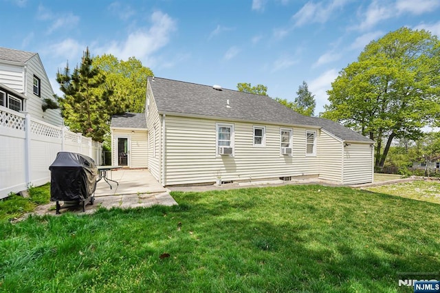 back of house featuring a yard, roof with shingles, fence, and a patio