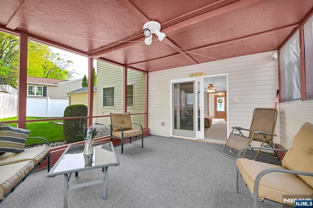 sunroom with a ceiling fan