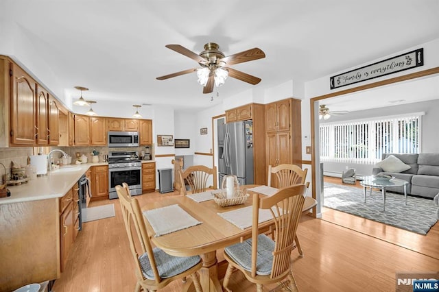 dining room featuring a ceiling fan and light wood-style floors