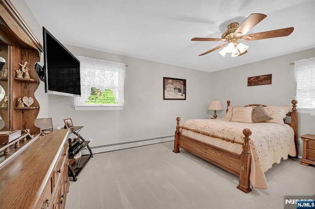 carpeted bedroom with a ceiling fan, multiple windows, and a baseboard radiator