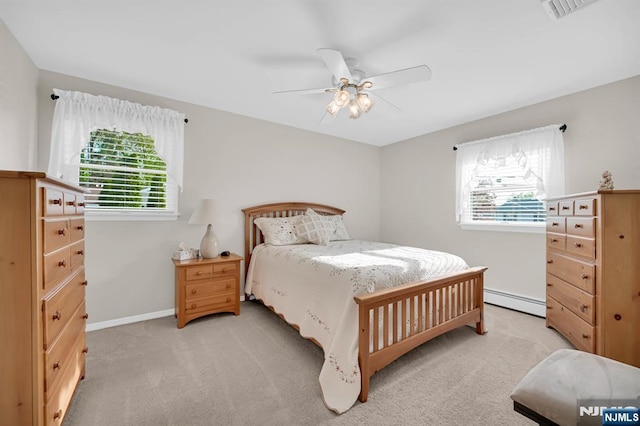 bedroom with a baseboard heating unit, visible vents, light carpet, a ceiling fan, and baseboards
