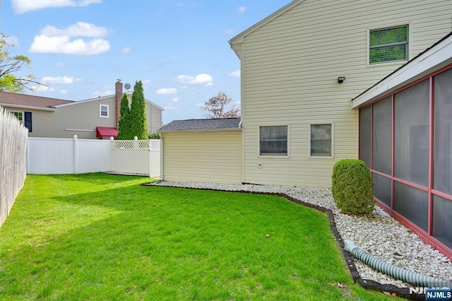 view of yard featuring fence private yard and a sunroom