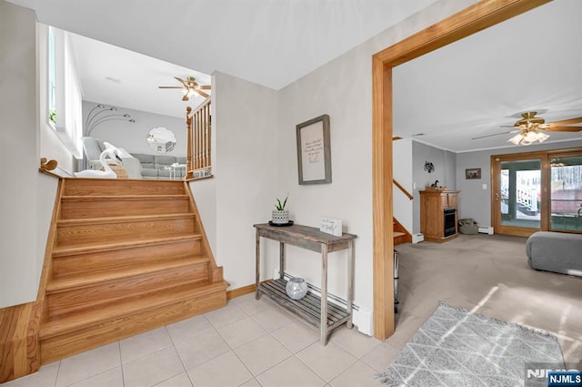 staircase with baseboards, tile patterned flooring, and ceiling fan