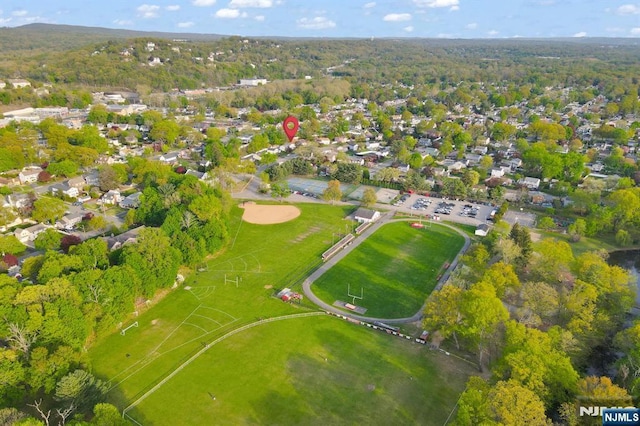 birds eye view of property with a view of trees