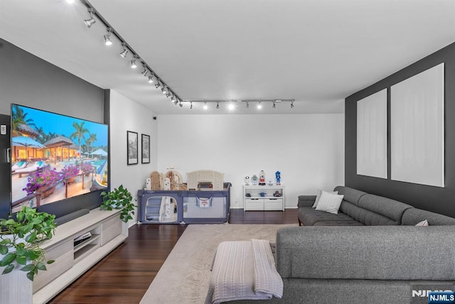 living room with baseboards, dark wood-style floors, and track lighting