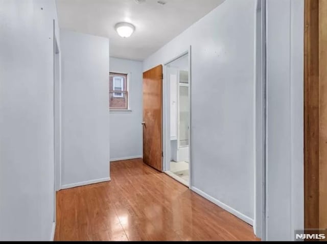 interior space featuring baseboards and wood finished floors