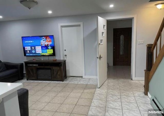 257 Palisade Ave, Garfield, NJ 07026 - living room with stairway, a baseboard heating unit, and recessed lighting