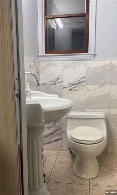 257 Palisade Ave, Garfield, NJ 07026 - bathroom with tile walls, tile patterned floors, and a wainscoted wall