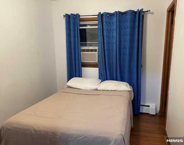 257 Palisade Ave, Garfield, NJ 07026 - bedroom with baseboard heating and wood finished floors