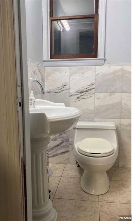 257 Palisade Ave, Garfield, NJ 07026 - half bath with tile walls and a wainscoted wall