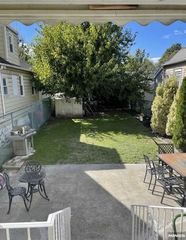 257 Palisade Ave, Garfield, NJ 07026 - fenced backyard with a patio area and outdoor dining space