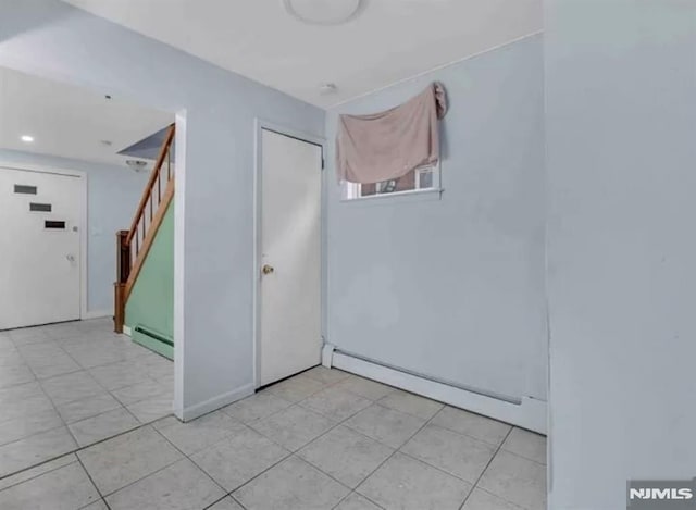 spare room with light tile patterned flooring, stairway, baseboard heating, and recessed lighting