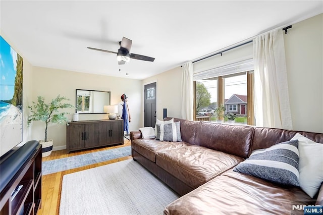 living room featuring wood finished floors and a ceiling fan