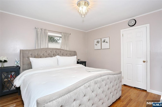 bedroom featuring light wood-style flooring, ornamental molding, and baseboards