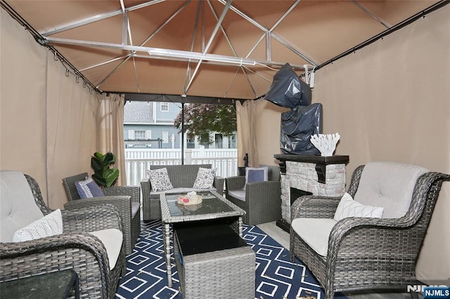 view of patio featuring a gazebo, an outdoor hangout area, and fence