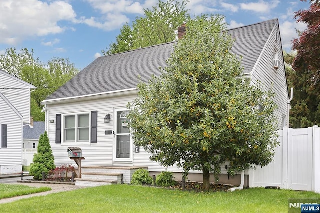 view of front of house with a chimney and a shingled roof