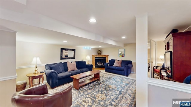 living area featuring a fireplace and recessed lighting