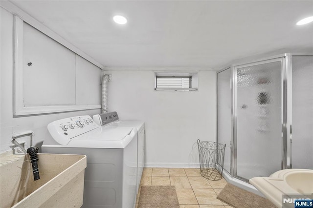 laundry area with independent washer and dryer, light tile patterned floors, baseboards, and recessed lighting