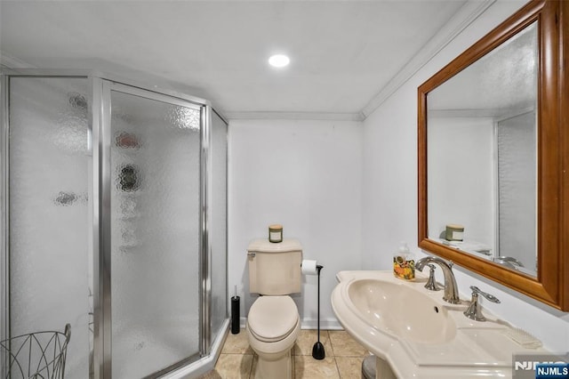 bathroom featuring a sink, a shower stall, toilet, and tile patterned flooring