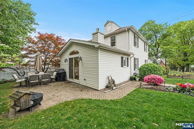 back of property with a patio area and a chimney