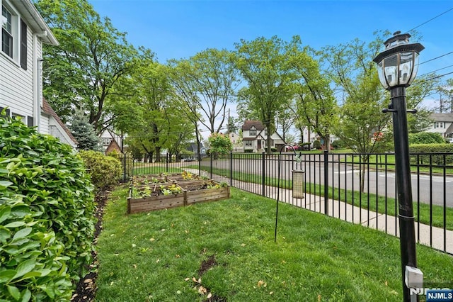 view of yard with a vegetable garden and a residential view