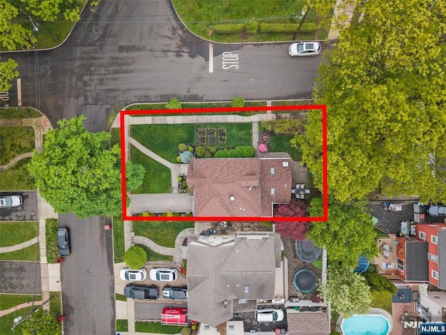 aerial view of property and surrounding area with property parcel outlined