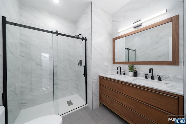 649 38th St Unit 409, Union City, NJ 07087 - bathroom with double vanity, a sink, tile patterned floors, and a shower stall