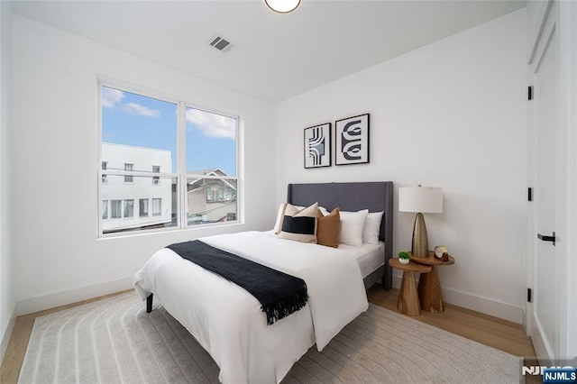 649 38th St Unit 409, Union City, NJ 07087 - bedroom with visible vents, baseboards, and wood finished floors