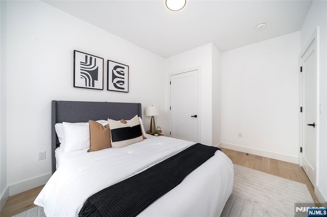649 38th St Unit 409, Union City, NJ 07087 - bedroom featuring a closet, baseboards, and light wood-style floors