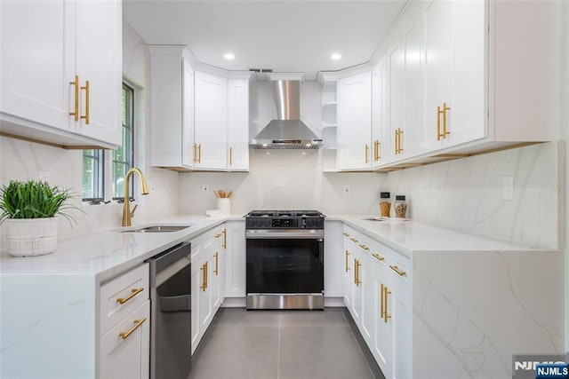 434 Argyle St, Oradell, NJ 07649 - kitchen with wall chimney range hood, range with gas stovetop, dishwasher, a sink, and light stone countertops