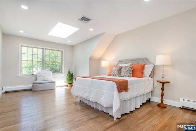 434 Argyle St, Oradell, NJ 07649 - bedroom featuring a skylight, a baseboard heating unit, wood finished floors, baseboards, and recessed lighting