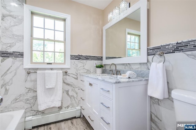 434 Argyle St, Oradell, NJ 07649 - full bath with baseboard heating, tile walls, plenty of natural light, vanity, and toilet
