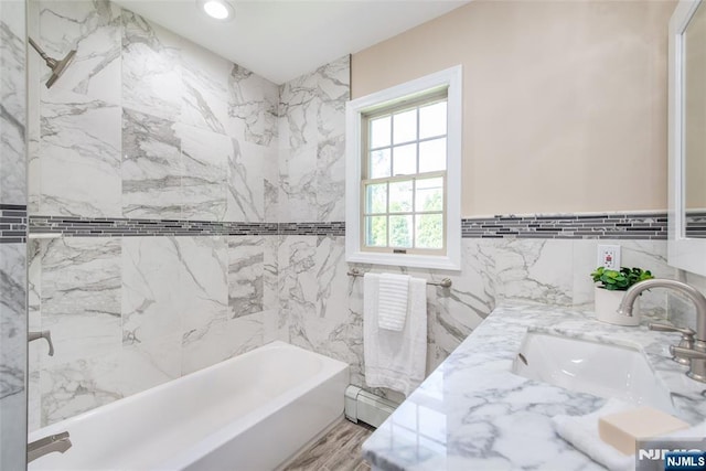 434 Argyle St, Oradell, NJ 07649 - bathroom with tile walls, a baseboard heating unit, bathtub / shower combination, vanity, and recessed lighting