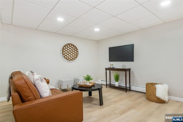 434 Argyle St, Oradell, NJ 07649 - living room with light wood-type flooring, baseboards, a baseboard radiator, recessed lighting, and a drop ceiling