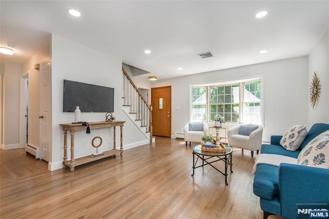 434 Argyle St, Oradell, NJ 07649 - living area featuring a baseboard heating unit, stairway, wood finished floors, recessed lighting, and a baseboard radiator