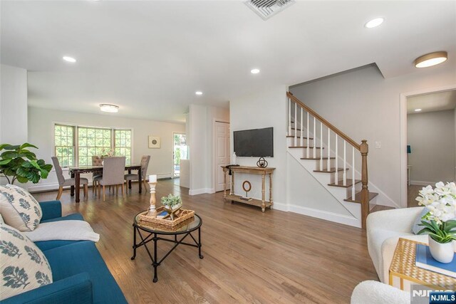434 Argyle St, Oradell, NJ 07649 - living area featuring stairs, wood finished floors, healthy amount of natural light, baseboards, and recessed lighting