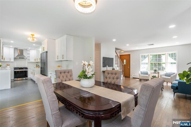 434 Argyle St, Oradell, NJ 07649 - dining area with stairway, recessed lighting, a baseboard heating unit, and wood finished floors