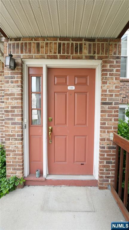 336 Village Ct Unit 3201, Fort Lee, NJ 07024 - view of exterior entry featuring brick siding