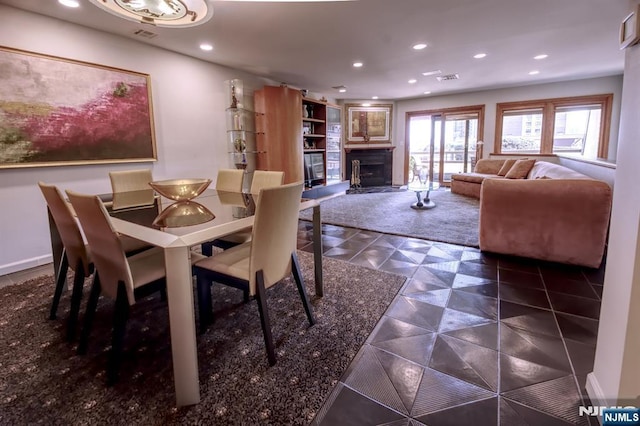 dining area featuring a fireplace and recessed lighting