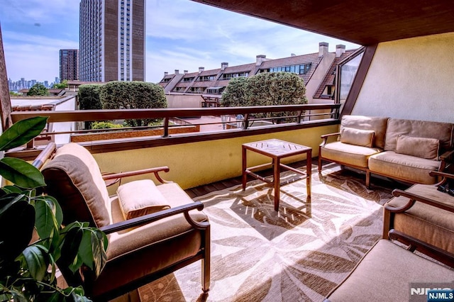 balcony featuring a view of city and an outdoor living space
