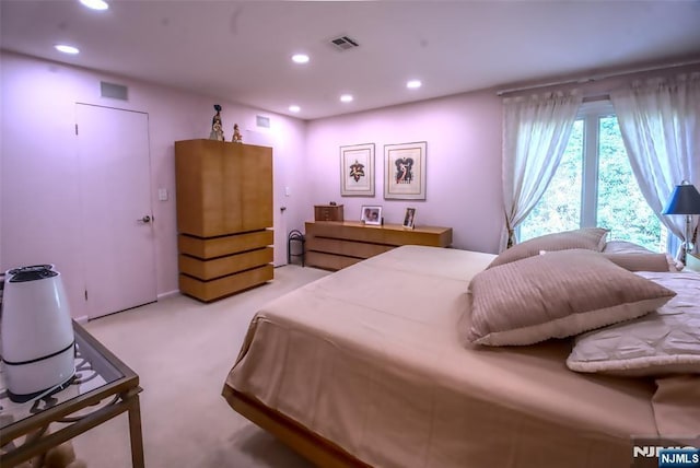 bedroom with recessed lighting and light carpet