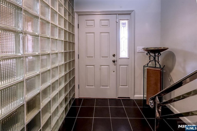 entryway featuring dark tile patterned flooring