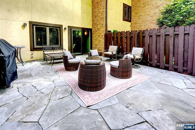 view of patio with fence and outdoor lounge area