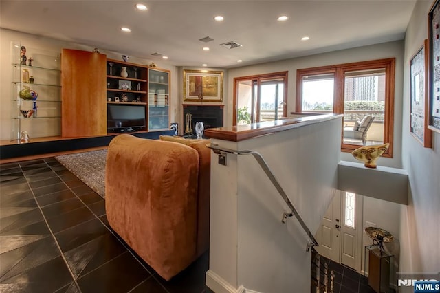 living area with recessed lighting, a fireplace, dark tile patterned floors, and baseboards