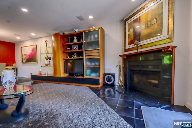 living area featuring a fireplace with flush hearth, tile patterned flooring, and recessed lighting