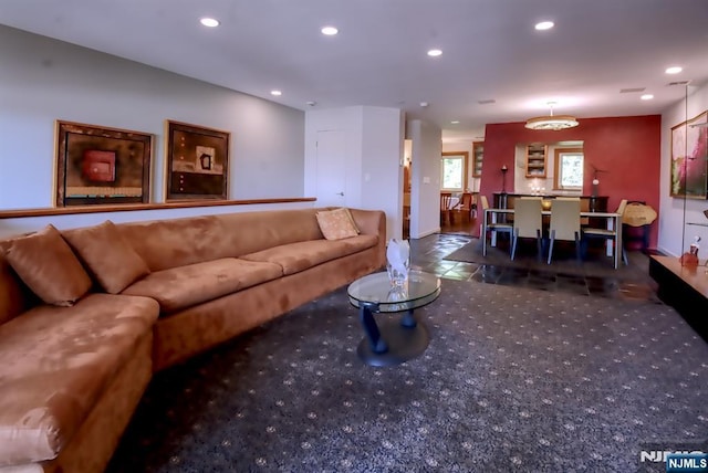 carpeted living area featuring recessed lighting and baseboards