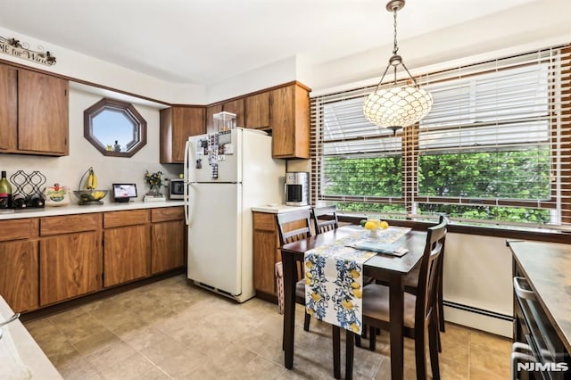 12-67 12th St, Fair Lawn, NJ 07410 - kitchen with freestanding refrigerator, plenty of natural light, and brown cabinetry