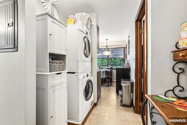 12-67 12th St, Fair Lawn, NJ 07410 - clothes washing area with stacked washer and clothes dryer and light tile patterned floors